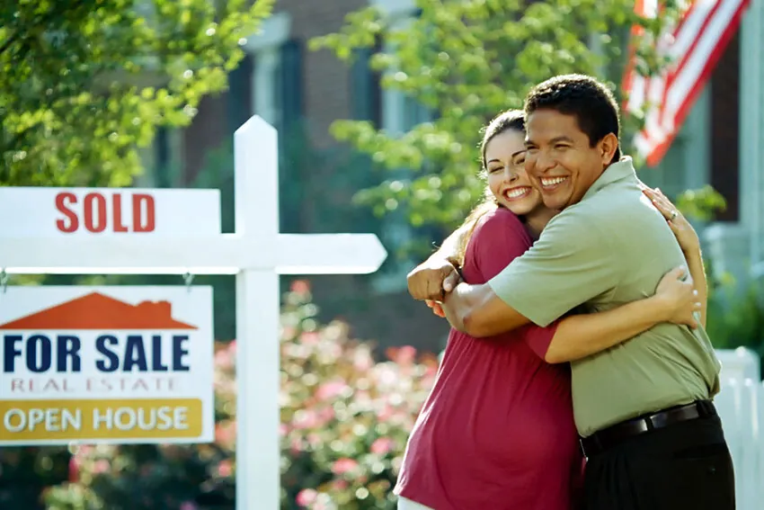 Couple holding keys to their new home