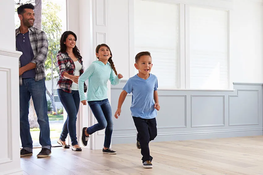 Family in front of their new home