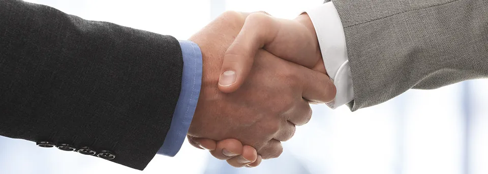 Two suited hands in handshake